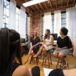 women sitting on chairs inside a room